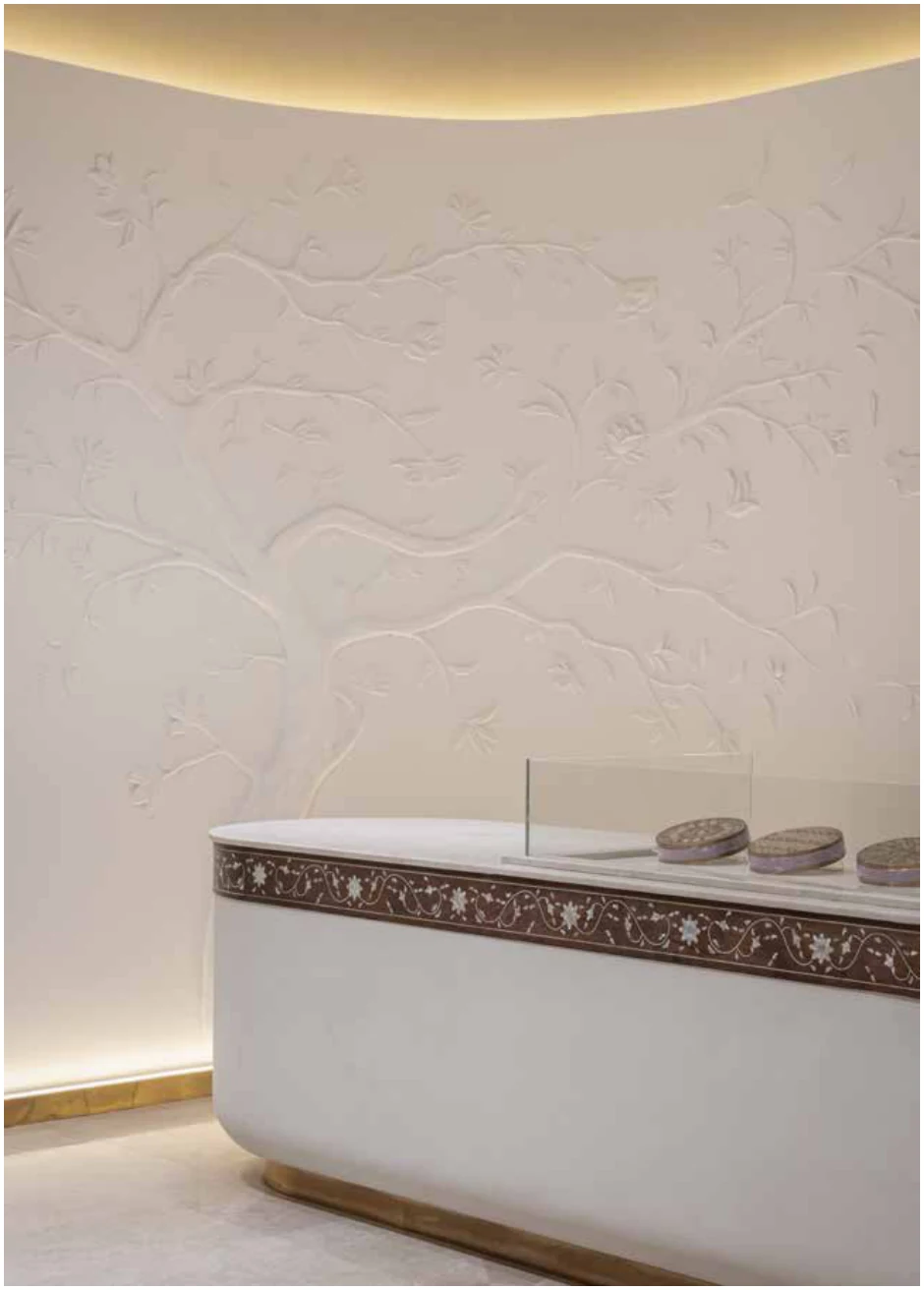 Curved counter with the floral relief wall