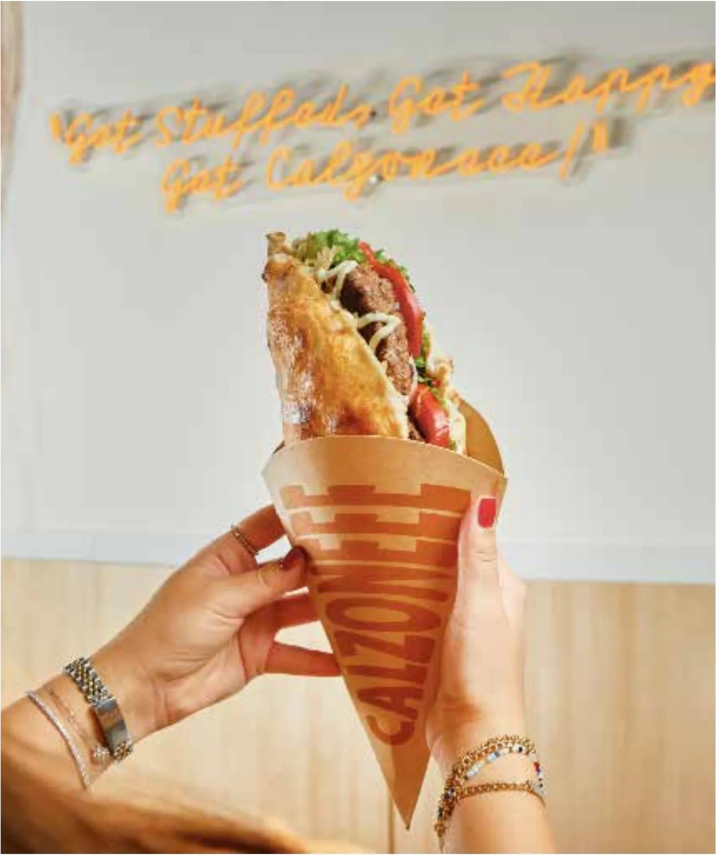 Hands holding a stuffed calzone