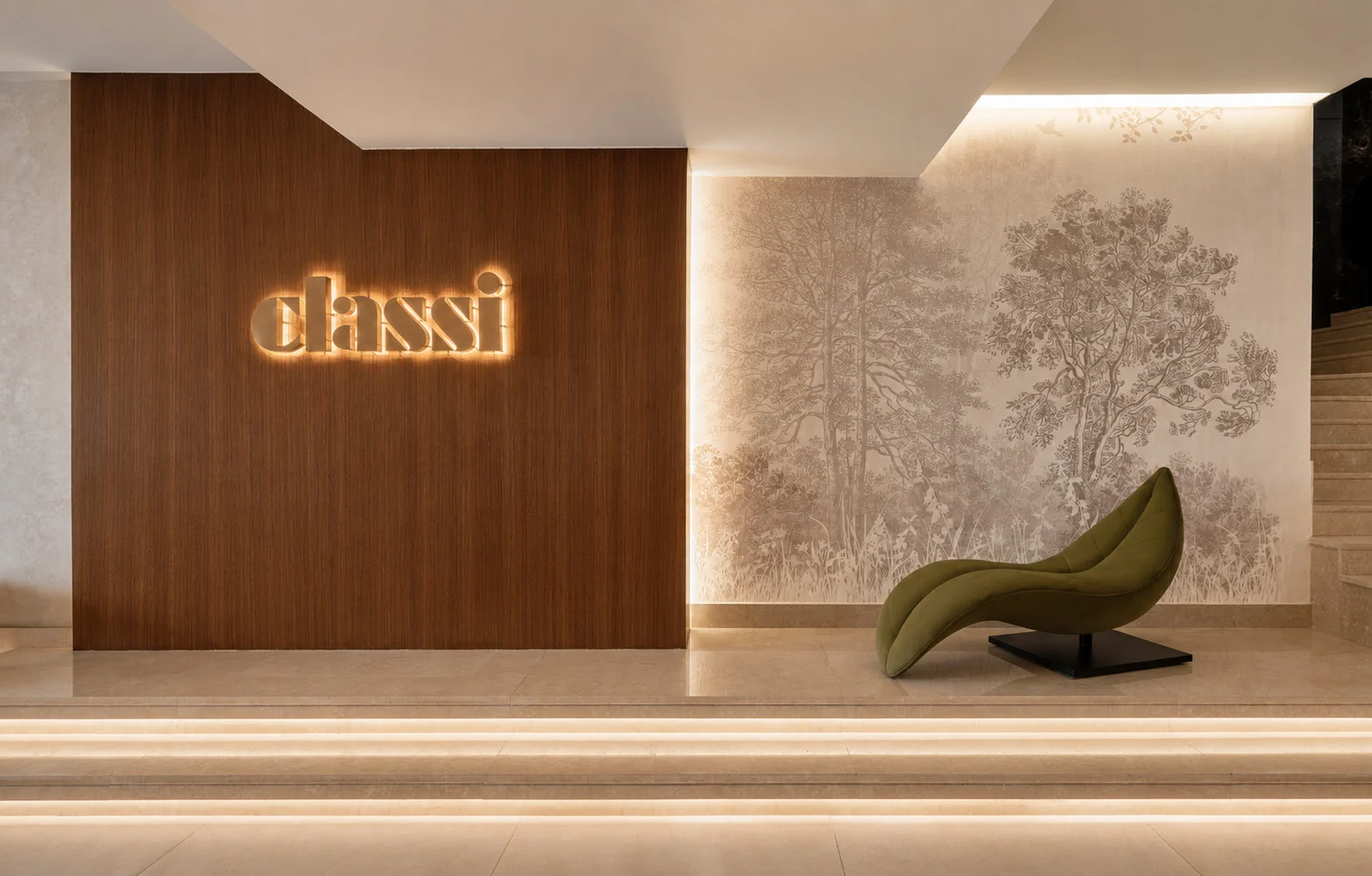 Classi entrance wall with backlit signage and a green lounge chair