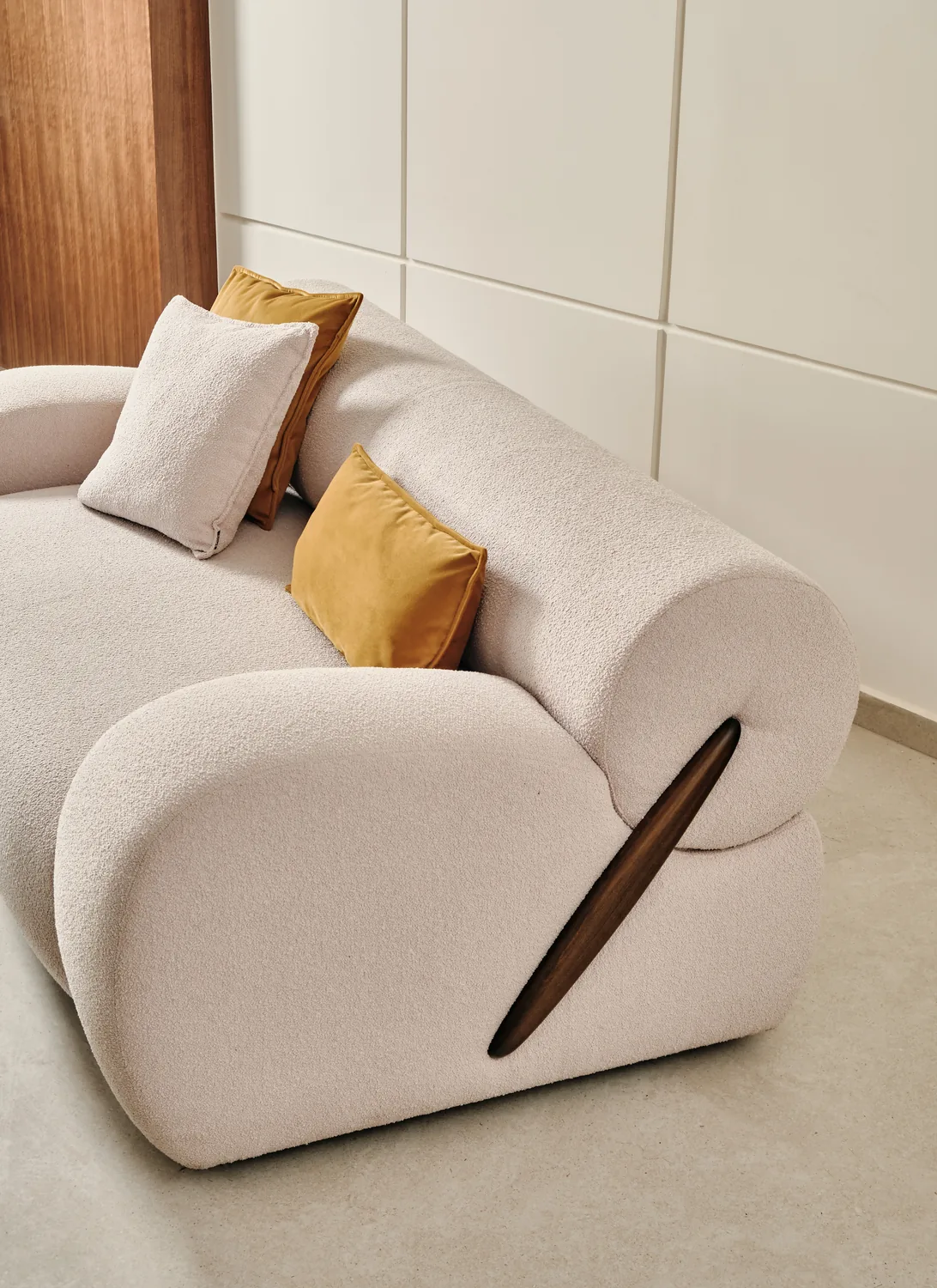 Boucle sofa with mustard cushion
