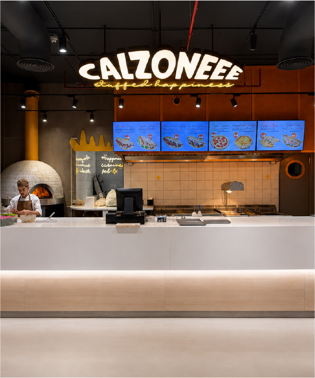 Calzoneee counter with illuminated brand sign