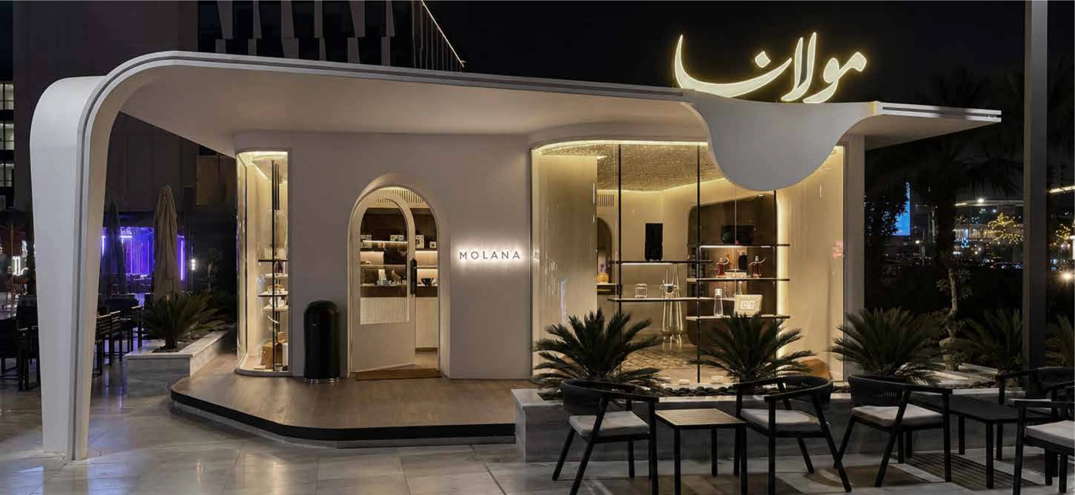 Molana façade with sculpted white canopy and glowing calligraphy sign
