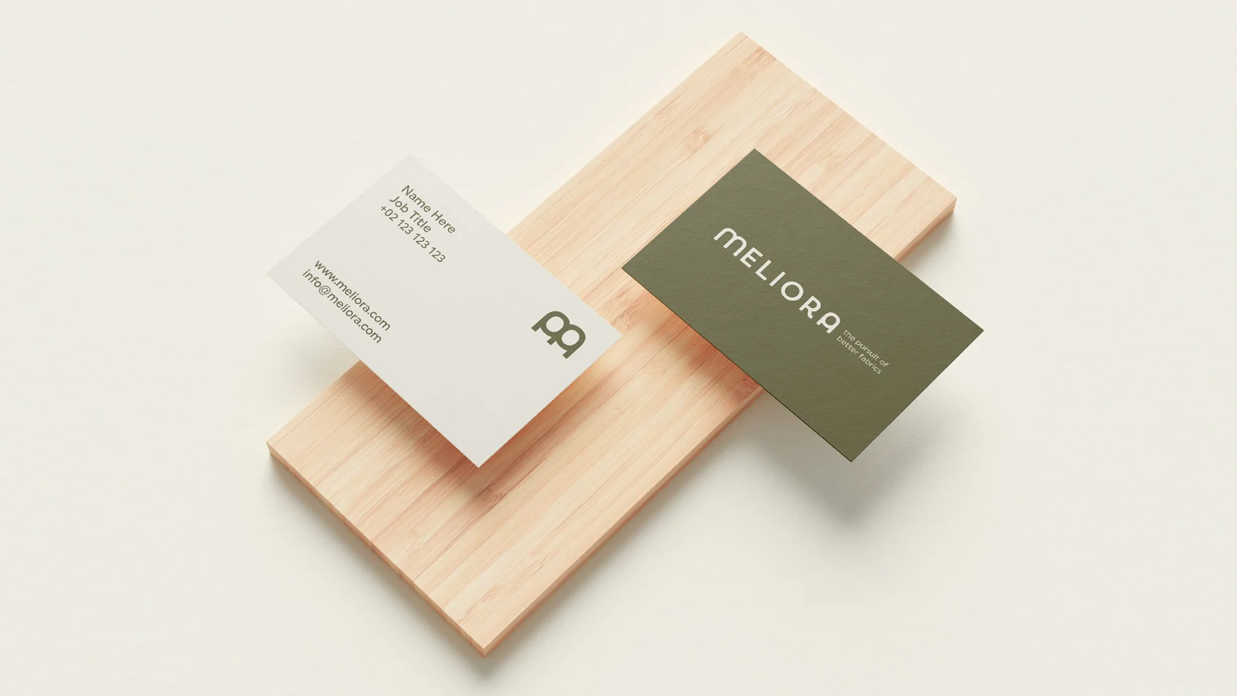 Meliora business cards on pale wood