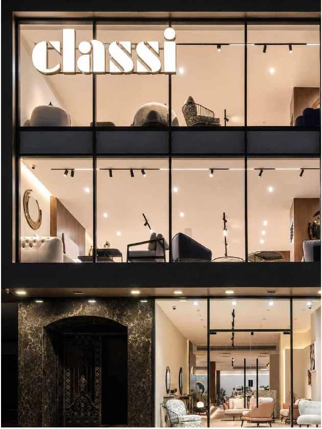 Double-height showroom windows glowing at night