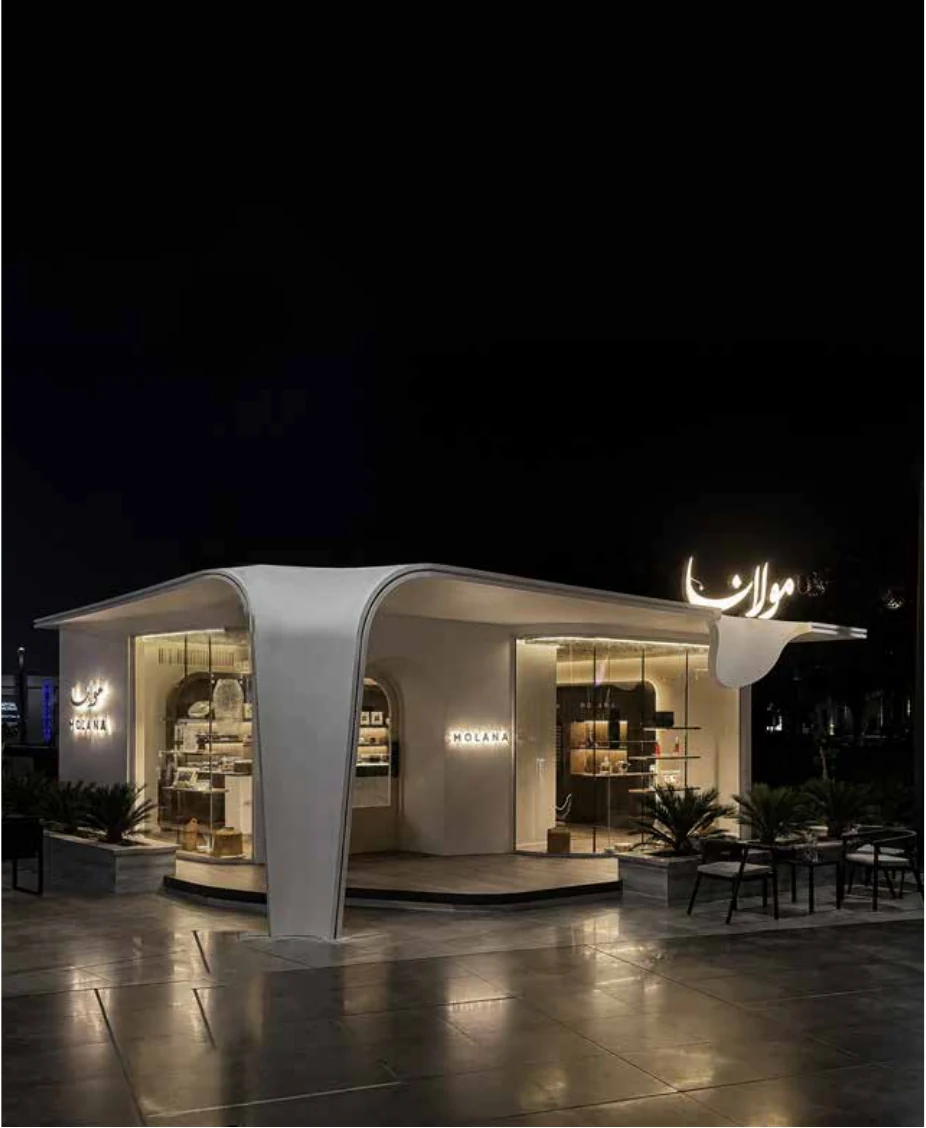 Molana storefront seen from the plaza at dusk