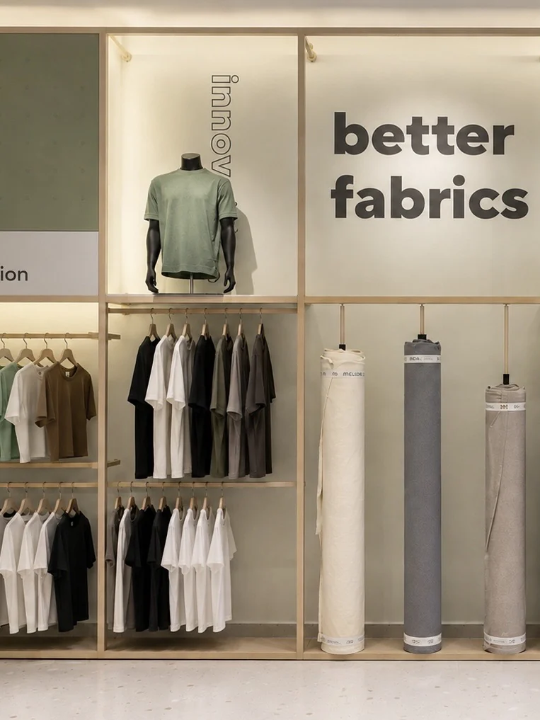 Built display wall with garments and fabric rolls