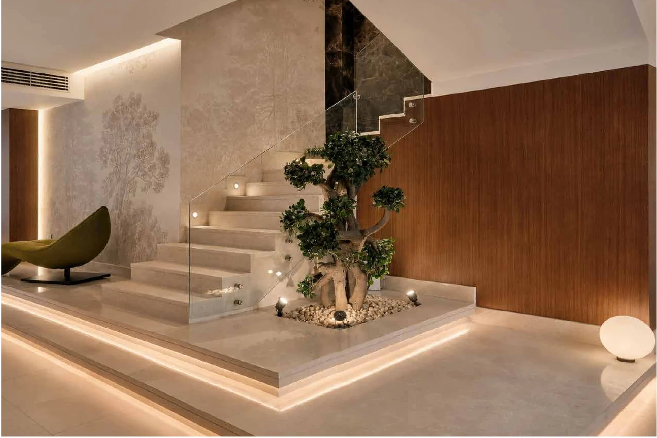 Sculptural staircase with planted feature and cove lighting