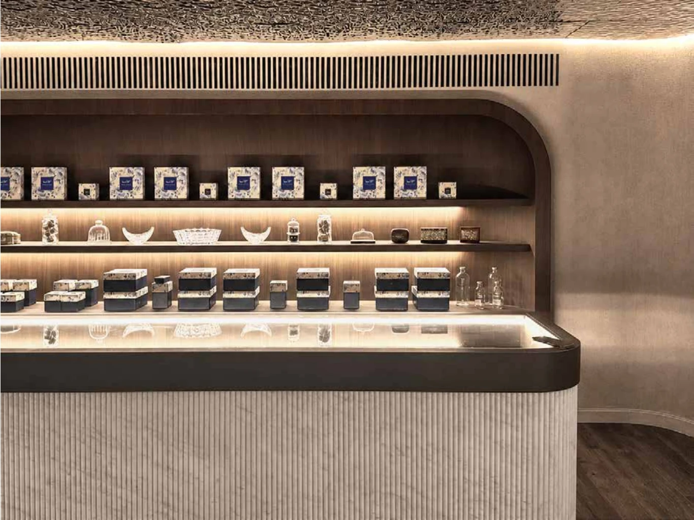 Pastry display cases along a textured stone wall